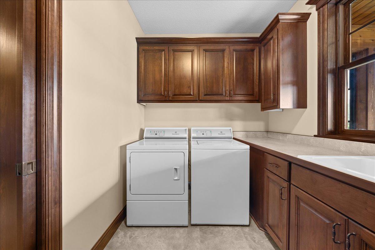 Laundry room with sink and lots of cabinetry.