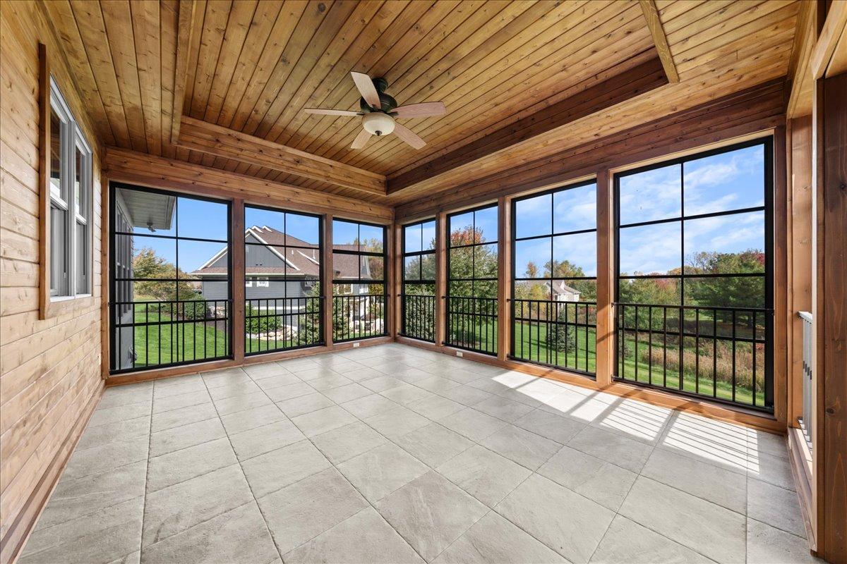 3 season porch with porcelain floors and tray ceiling.