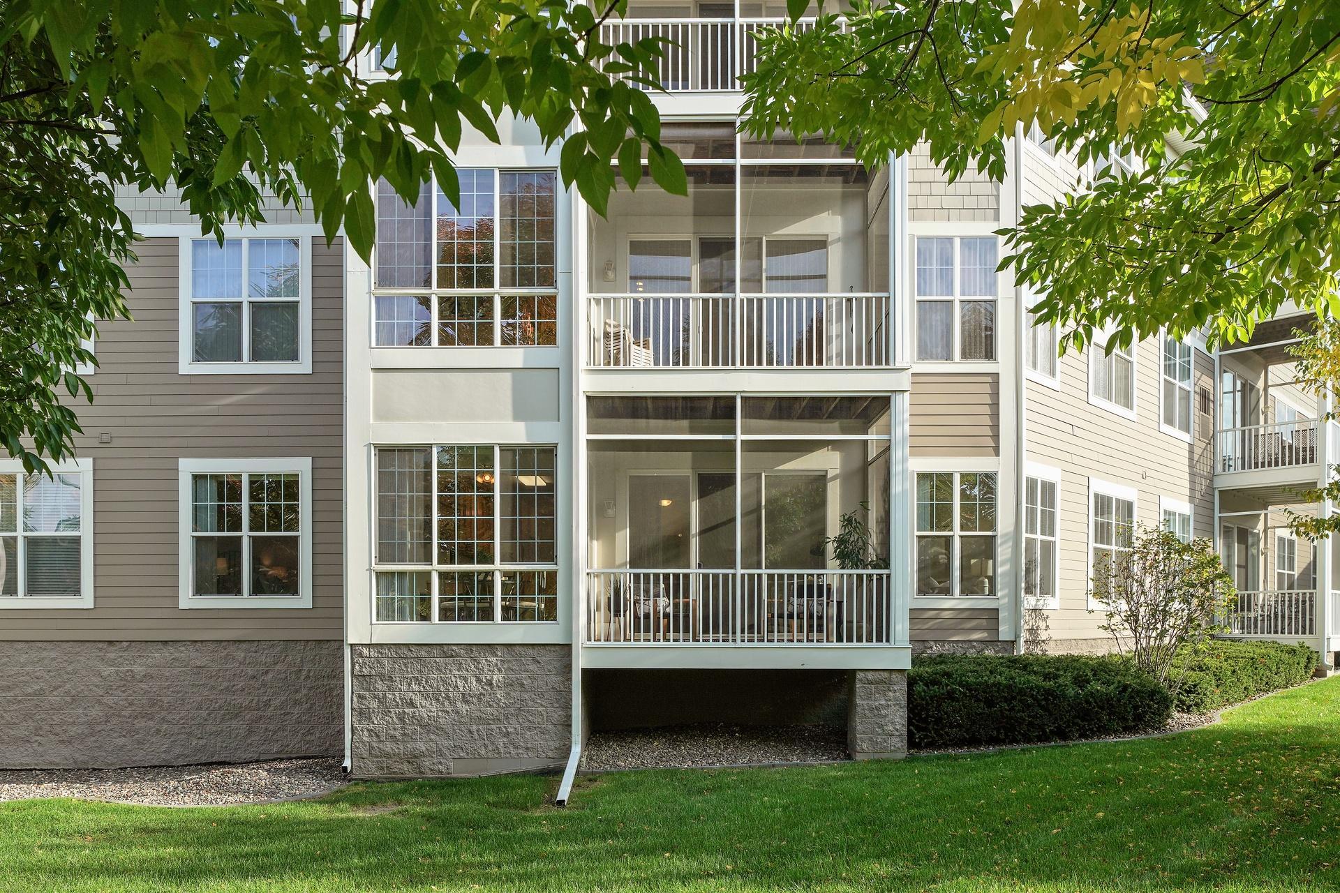 First floor unit with large windows and screen porch