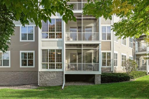 First floor unit with large windows and screen porch