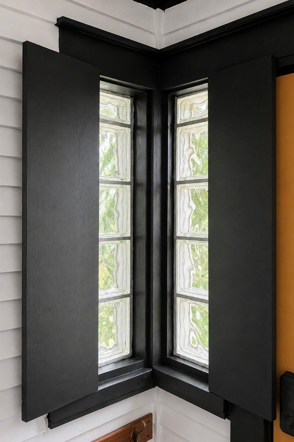 The corner glass block windows with little doors.