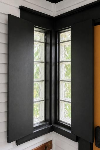 The corner glass block windows with little doors.