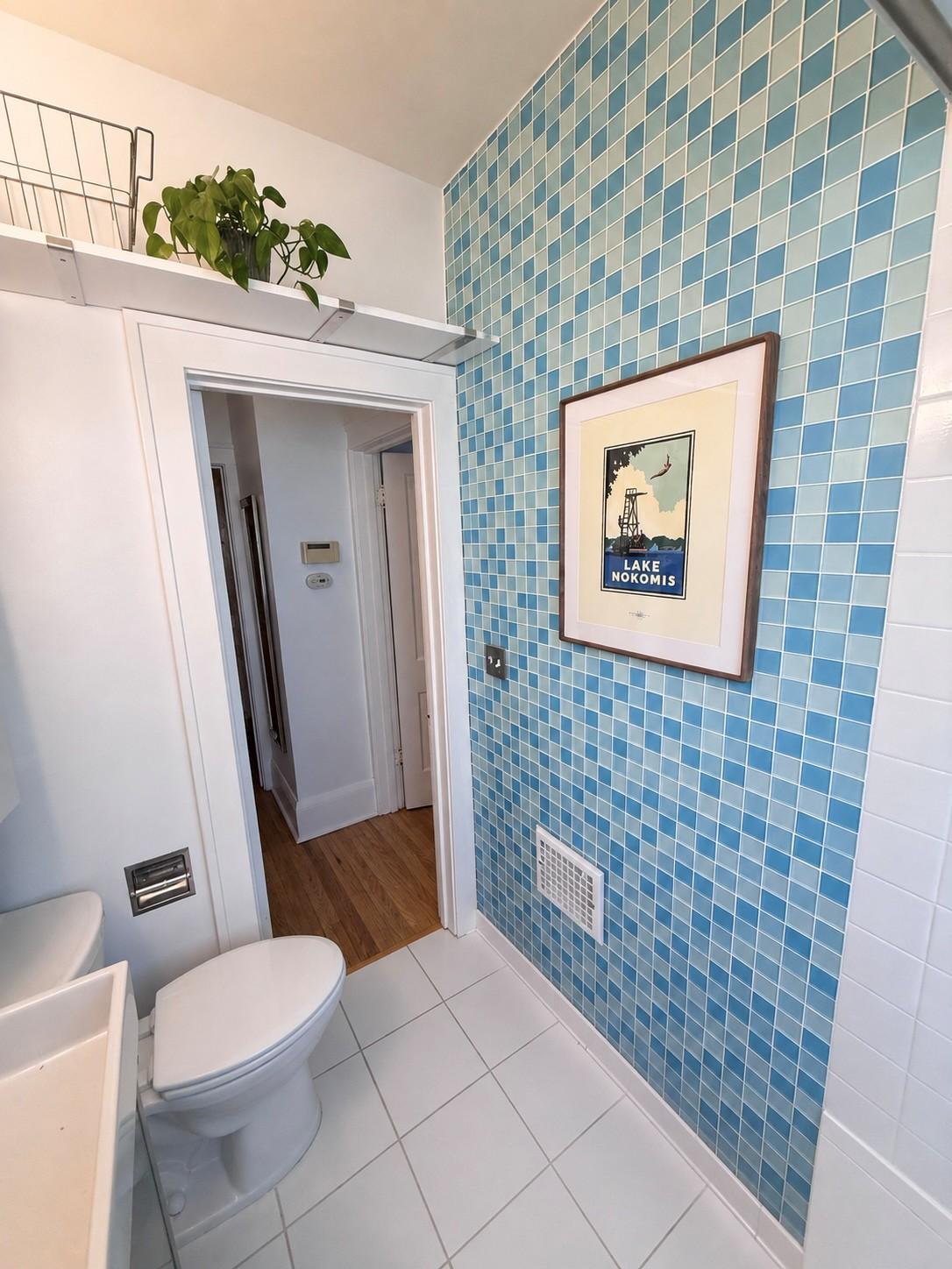 The tiled walls, glass block window, and over the doorway storage is perfect.