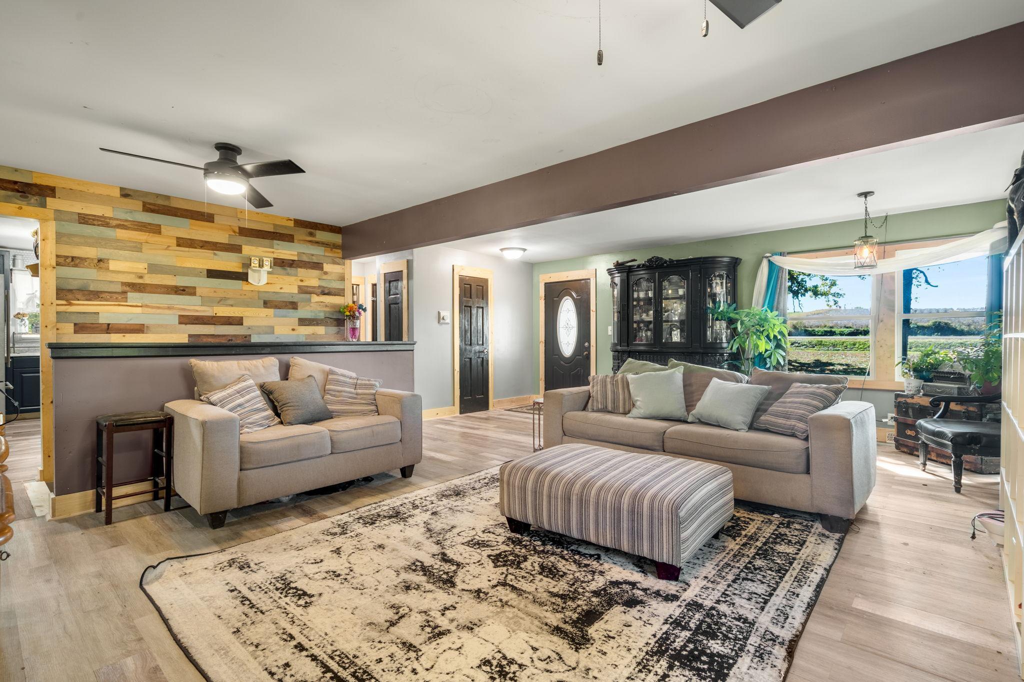 An open, spacious living area with updated flooring, abundant natural light and plenty of room to gather.