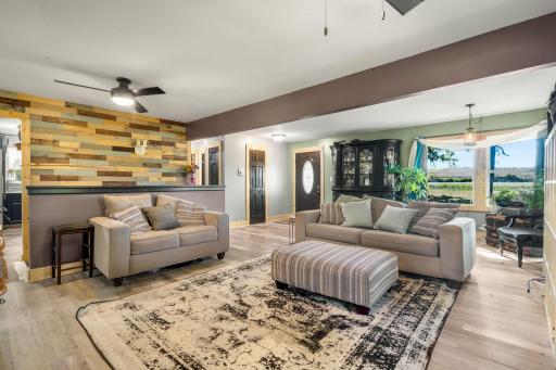 An open, spacious living area with updated flooring, abundant natural light and plenty of room to gather.
