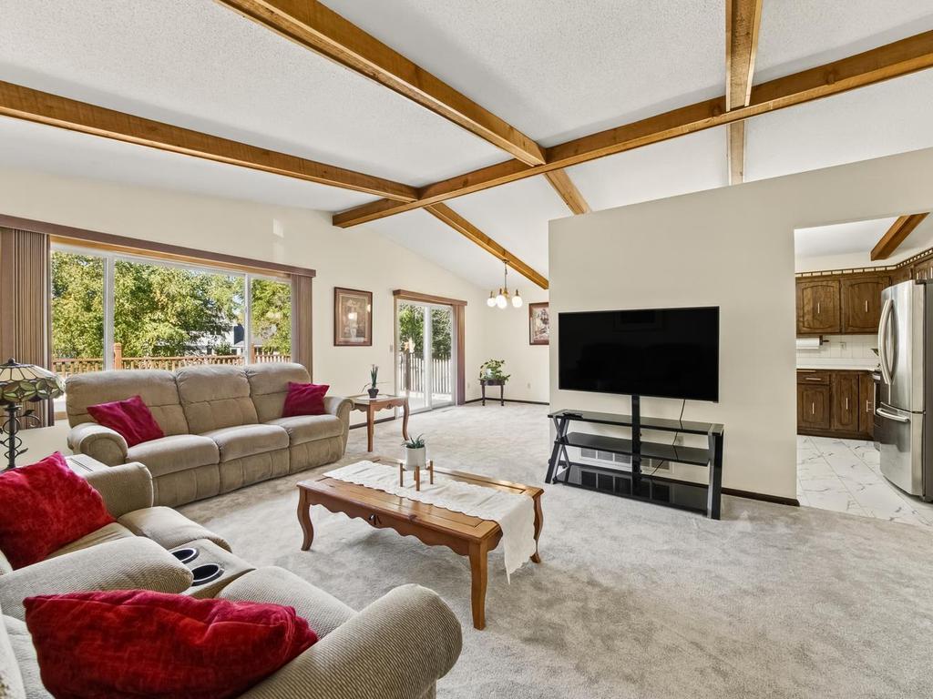 Living room features vaulted ceiling. New carpet and Anderson windows installed in 2022.