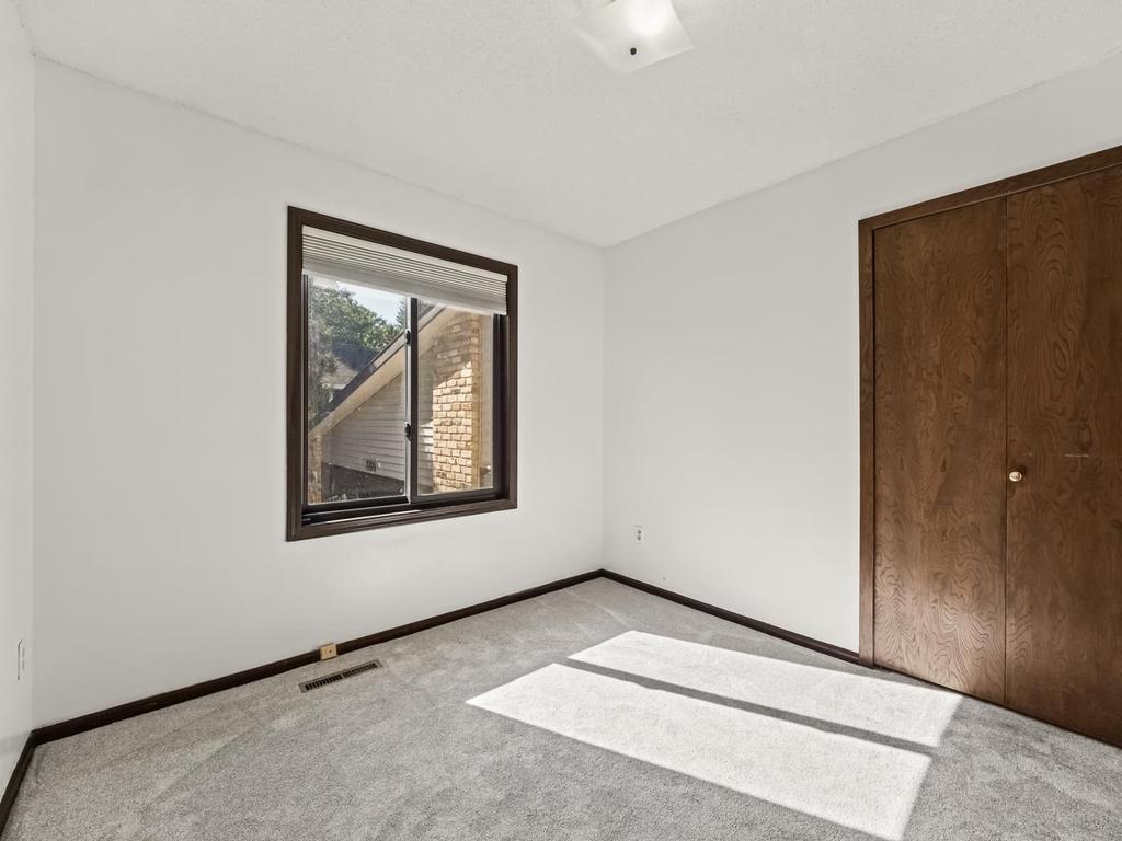 2nd of 3 main floor bedrooms . New carpet installed installed thruout the home in 2022!