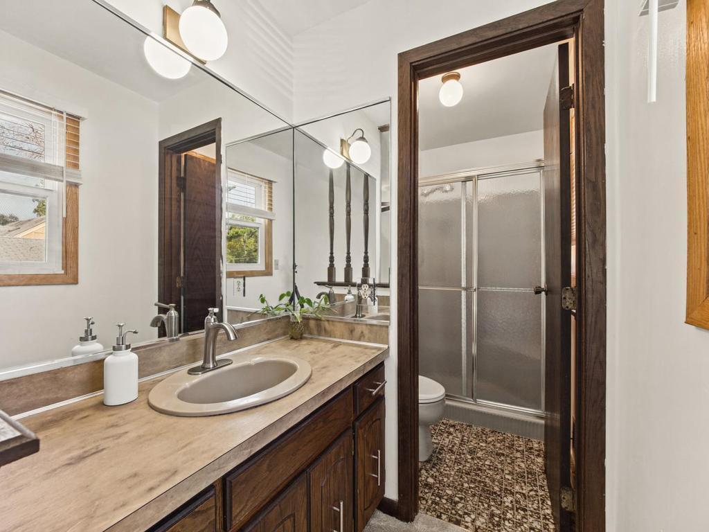 Primary private 3/4 bathroom with walk-in shower. Sink /vanity seperated from shower /toilet area.