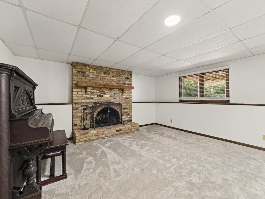 Wood burning fireplace to warm you up on a cool winter evening. Large lookout windows face the backyard under the deck.