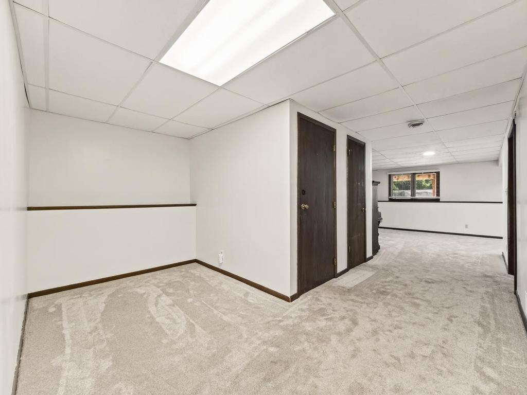 This area tto the left of the stairs could be an office or den/sitting area