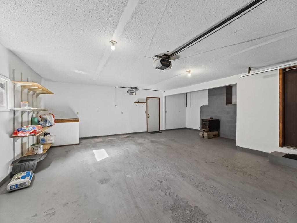 Oversized extra deep garage . The old pot belly fireplace stored in garage temporarily and will be removed prior to closing