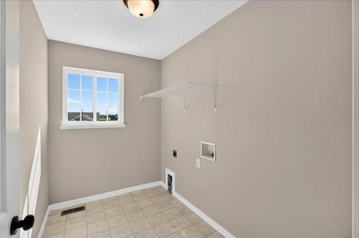 PHOTO OF A DIFFERENT HOME WITH SIMILAR PLAN AND FINISHES. Upper Floor Laundry Room convenient to the bedrooms.