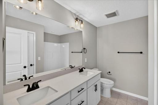 PHOTO OF A DIFFERENT HOME WITH SIMILAR PLAN AND FINISHES. Primary Suite Private Bathroom.