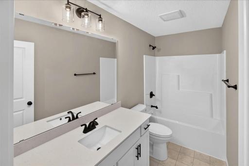 PHOTO OF A DIFFERENT HOME WITH SIMILAR PLAN AND FINISHES. Upper Main Full Bathroom.