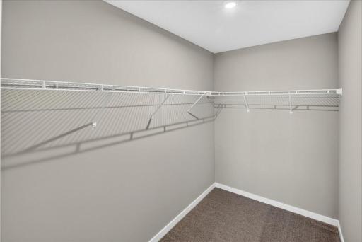 PHOTO OF A DIFFERENT HOME WITH SIMILAR PLAN AND FINISHES. Primary Suite Walk-in Closet.