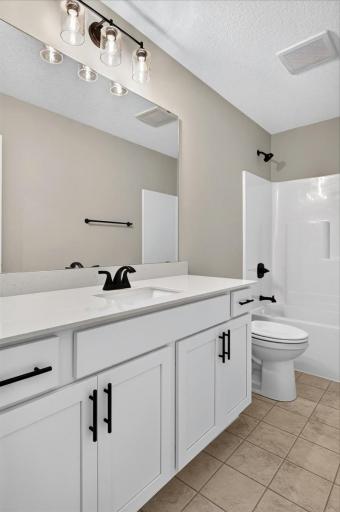 PHOTO OF A DIFFERENT HOME WITH SIMILAR PLAN AND FINISHES. Upper Main Full Bathroom.