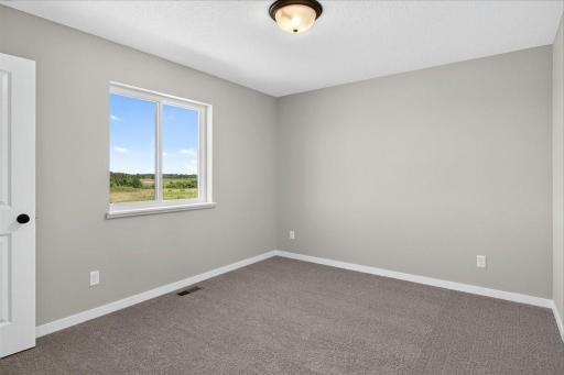 PHOTO OF A DIFFERENT HOME WITH SIMILAR PLAN AND FINISHES. Bedroom 4.