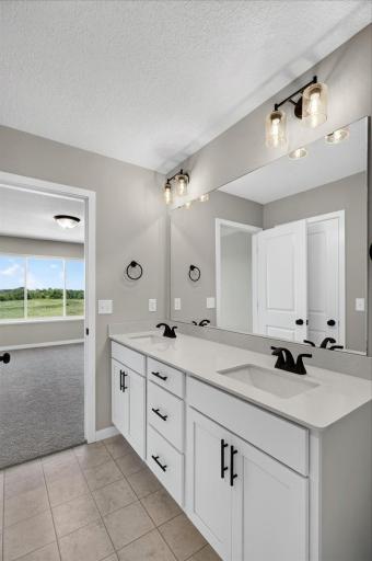 PHOTO OF A DIFFERENT HOME WITH SIMILAR PLAN AND FINISHES. Primary Suite Private Bathroom.