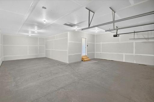 PHOTO OF A DIFFERENT HOME WITH SIMILAR PLAN AND FINISHES. Spacious 4 Bay Garage offering an abundance of space for storage and work area.