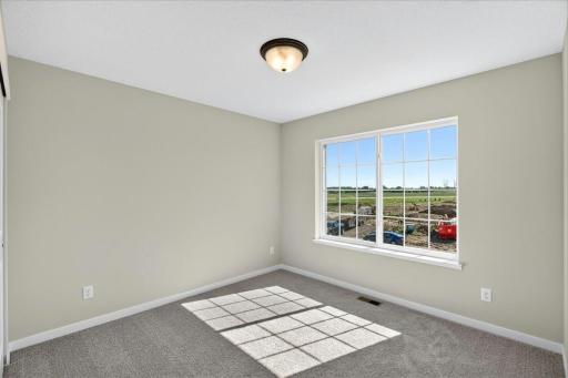 PHOTO OF A DIFFERENT HOME WITH SIMILAR PLAN AND FINISHES. Bedroom 3.