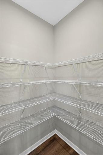 PHOTO OF A DIFFERENT HOME WITH SIMILAR PLAN AND FINISHES. Kitchen Pantry.