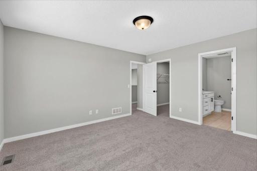 PHOTO OF A DIFFERENT HOME WITH SIMILAR PLAN AND FINISHES. Primary Suite.