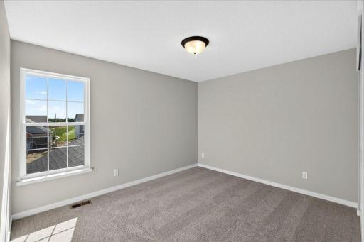 PHOTO OF A DIFFERENT HOME WITH SIMILAR PLAN AND FINISHES. Bedroom 2.