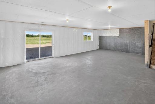 PHOTO OF A DIFFERENT HOME WITH SIMILAR PLAN AND FINISHES. Unfinished Walkout Lower Level ready for future finish.