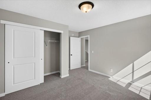 PHOTO OF A DIFFERENT HOME WITH SIMILAR PLAN AND FINISHES. Bedroom 2.