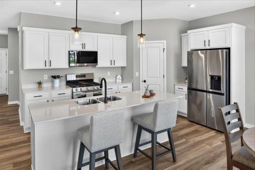 PHOTO OF A DIFFERENT HOME WITH SIMILAR PLAN AND FINISHES.