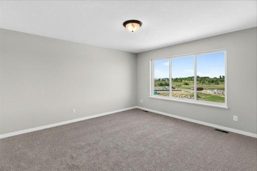 PHOTO OF A DIFFERENT HOME WITH SIMILAR PLAN AND FINISHES. Primary Suite.