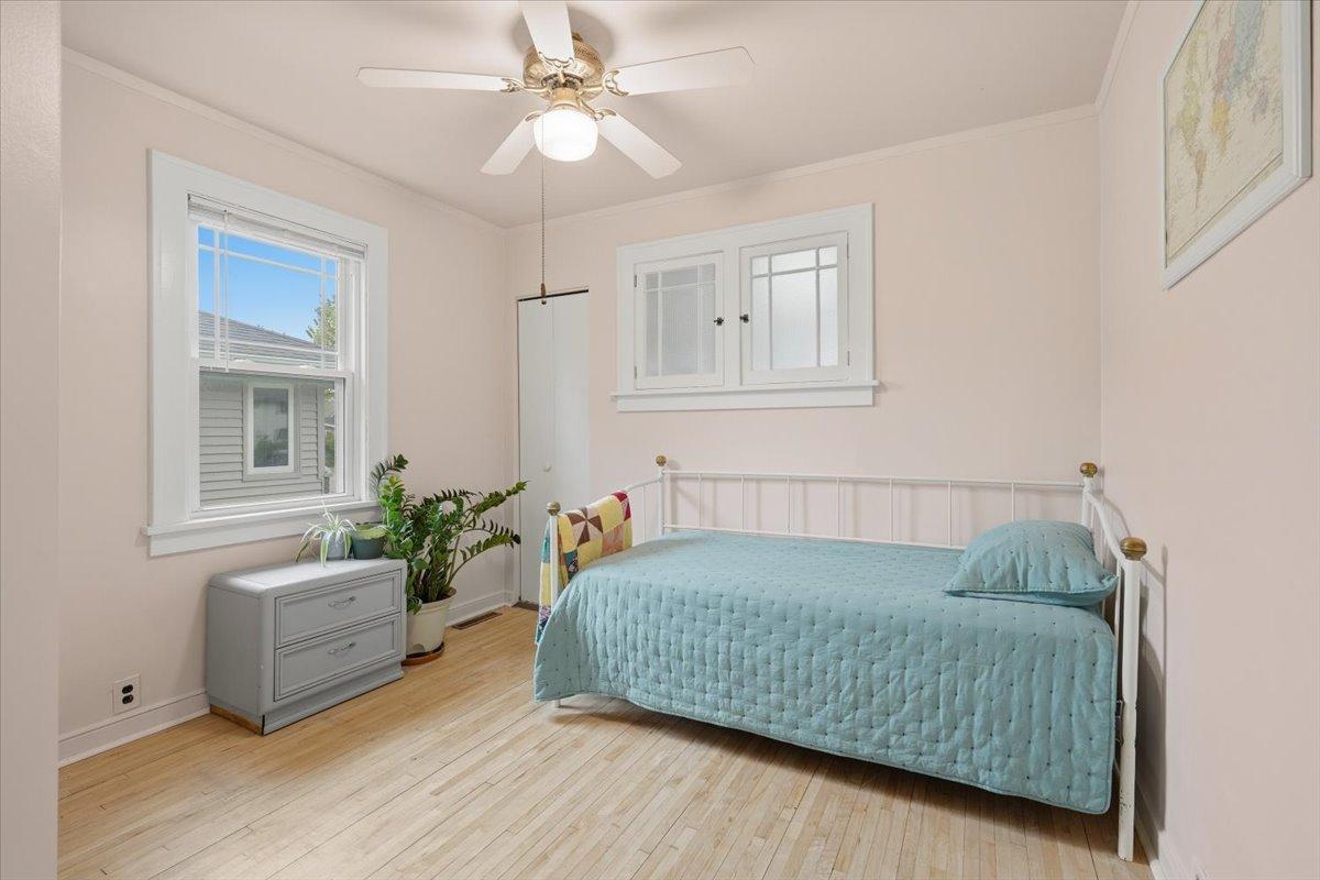 The main-level bedroom offers hardwood floors, ceiling fan, natural light and the convenience of having a bedroom on each level.