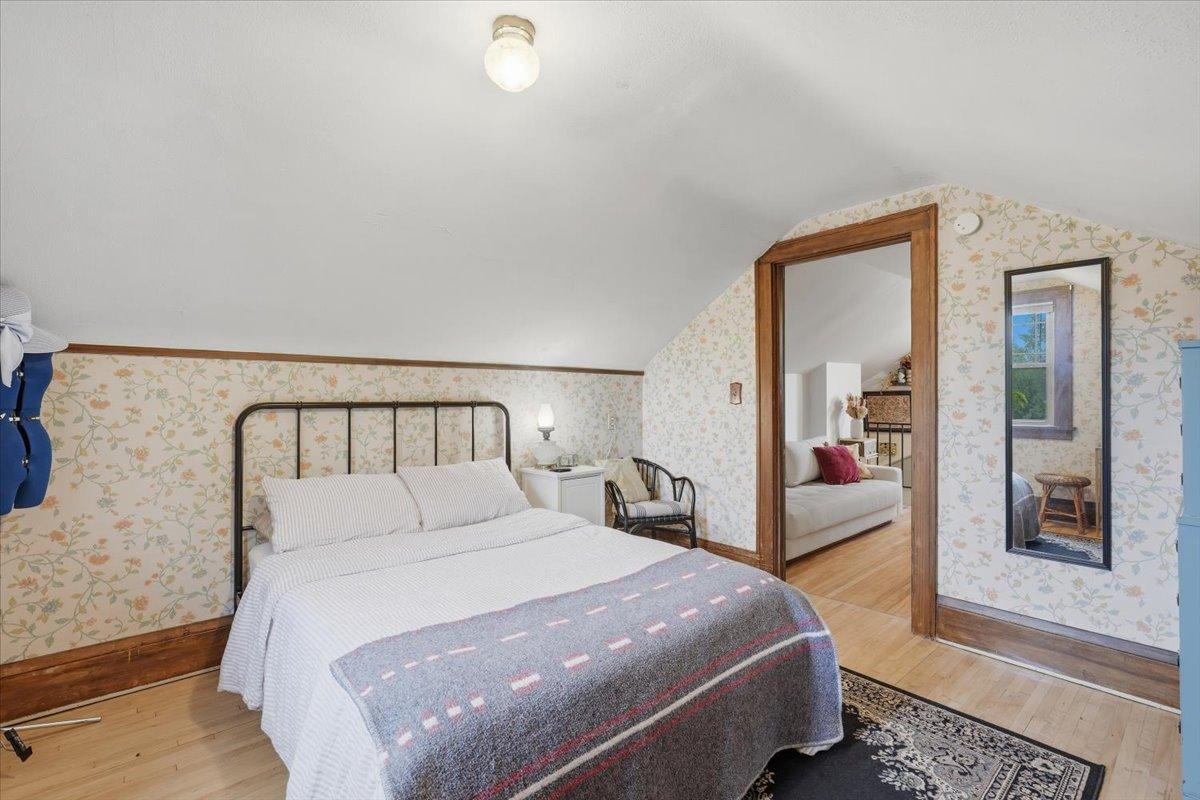 There's something especially cozy about the upper level bedroom with the original woodwork details...