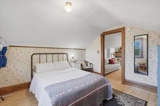 There's something especially cozy about the upper level bedroom with the original woodwork details...