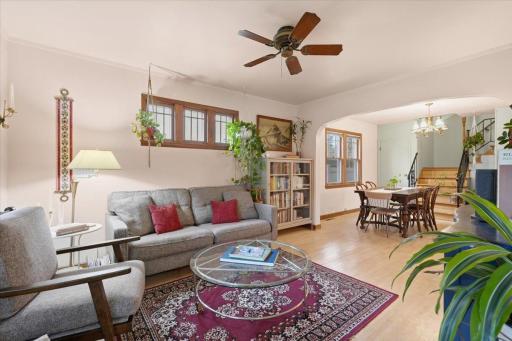 An arched opening connects the living and dining spaces, while refinished hardwood floors and original woodwork bring warmth throughout the main level.