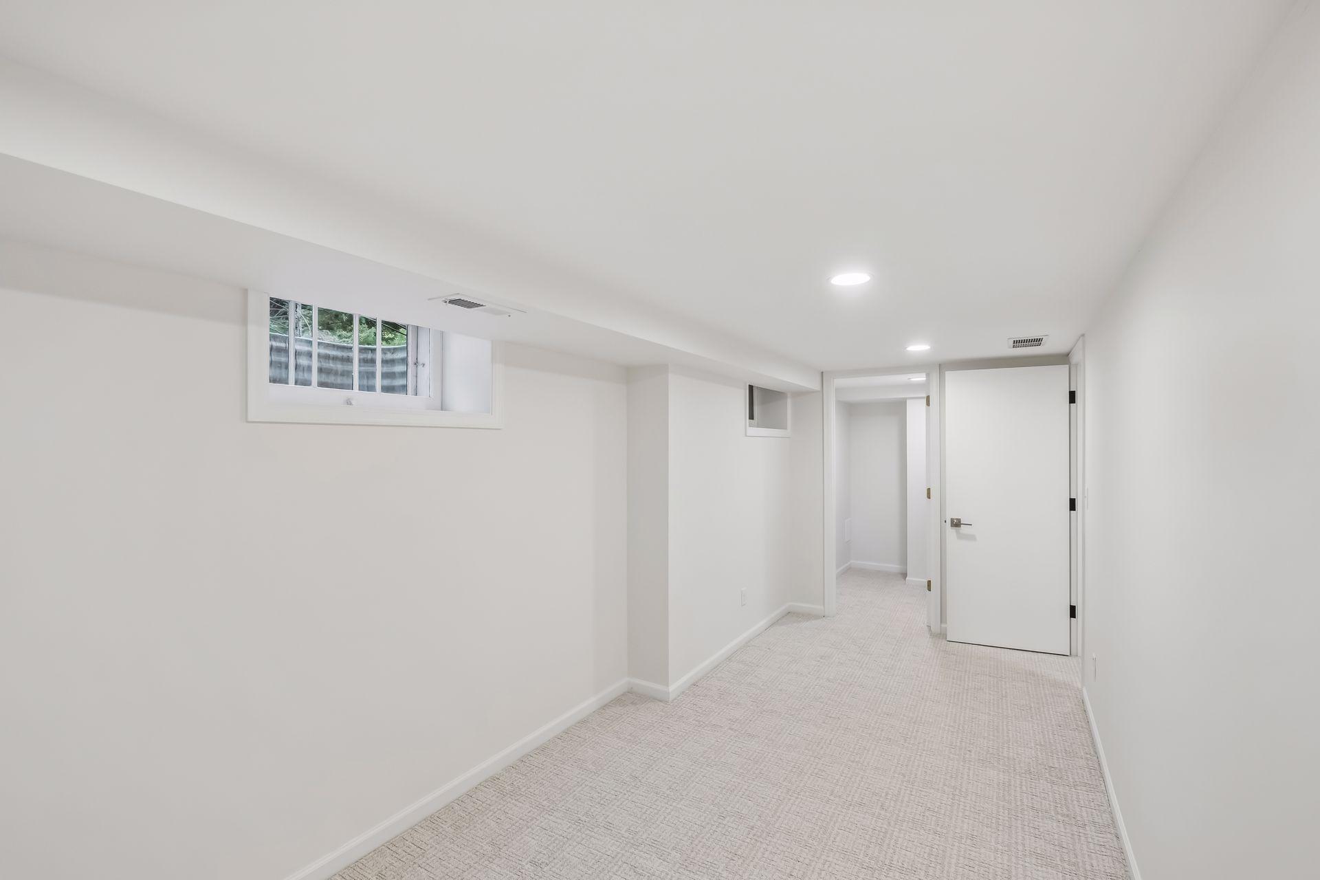 Lower Level room at base of steps, with huge walk in closet can be used for many reasons, including a 4th non-conforming bed, office, play room, study, and more.