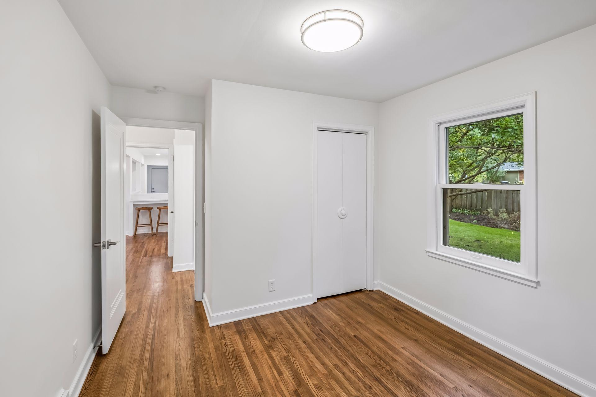 Bedroom #3 with Beautiful views of back and side yard, close to kitchen and full bath outside door.