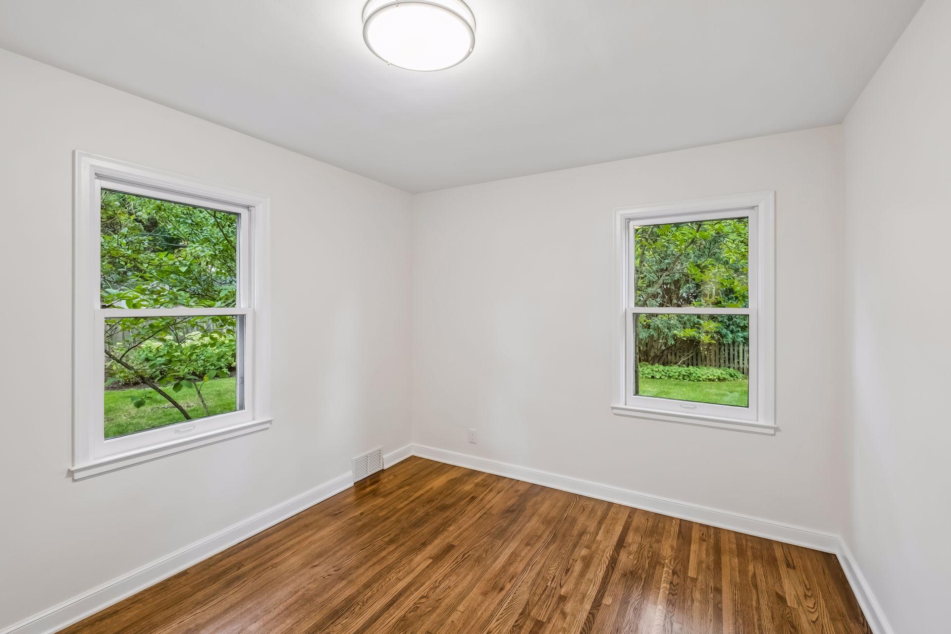 Freshly painted and natural wood two walls with Windows floors, new lighting fixtures.