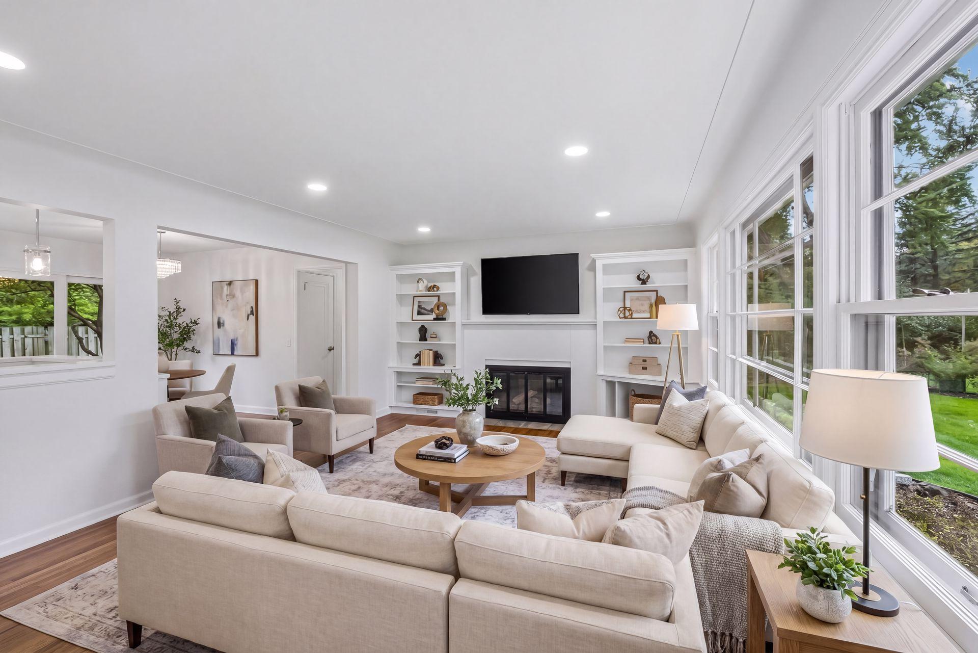 This photo is virtually staged. Main Level family room opens up to the kitchen, access backyard from kitchen glass sliders, warm up with a cozy gas fireplace. huge wall of glass adds tons of natural sunlight.