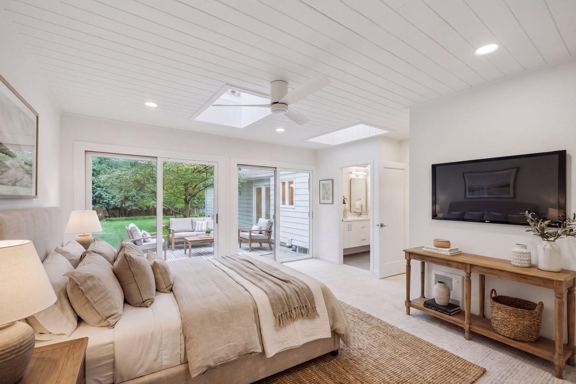 This photo is virtually staged. Primary Bedroom suite on Main level, step outside to the patio for a nice cup of coffee.