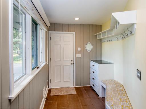 Built-in seating and ample storage make this mudroom foyer both functional and welcoming.