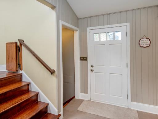 Looking back at the inviting foyer which welcomes you with tile flooring and charming wainscoting.