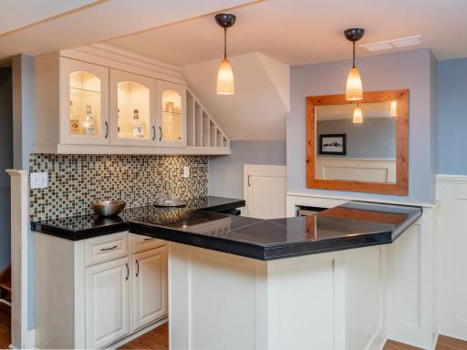 A stylish lower-level bar creates the perfect setting for entertaining, relaxing and gathering with friends and family.