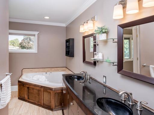 Ensuite with dual sink vanity, soaking tub and walk-in shower.