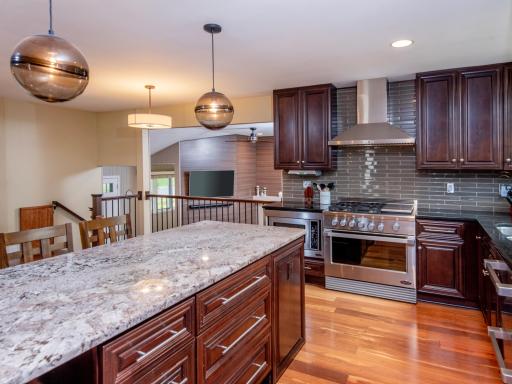 Thoughtfully updated, this kitchen boasts custom cherry cabinetry, high-end appliances, granite countertops and a beautiful tile backsplash.