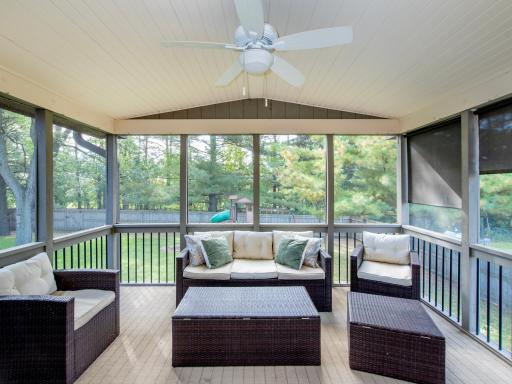 A stunning three-season porch offers a peaceful retreat with beautiful views of the private backyard.