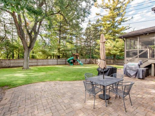 A beautiful paver patio provides the perfect spot to enjoy the expansive, private backyard.