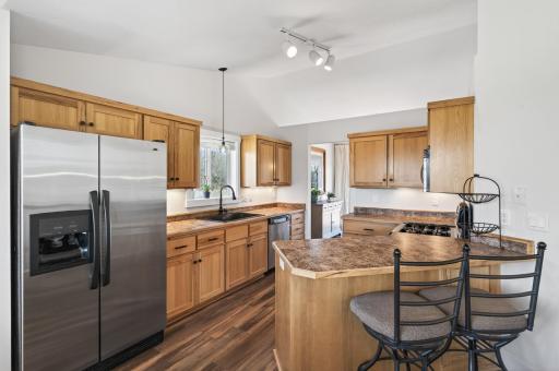Upper level kitchen has stainless appliances including a gas range & new fixtures