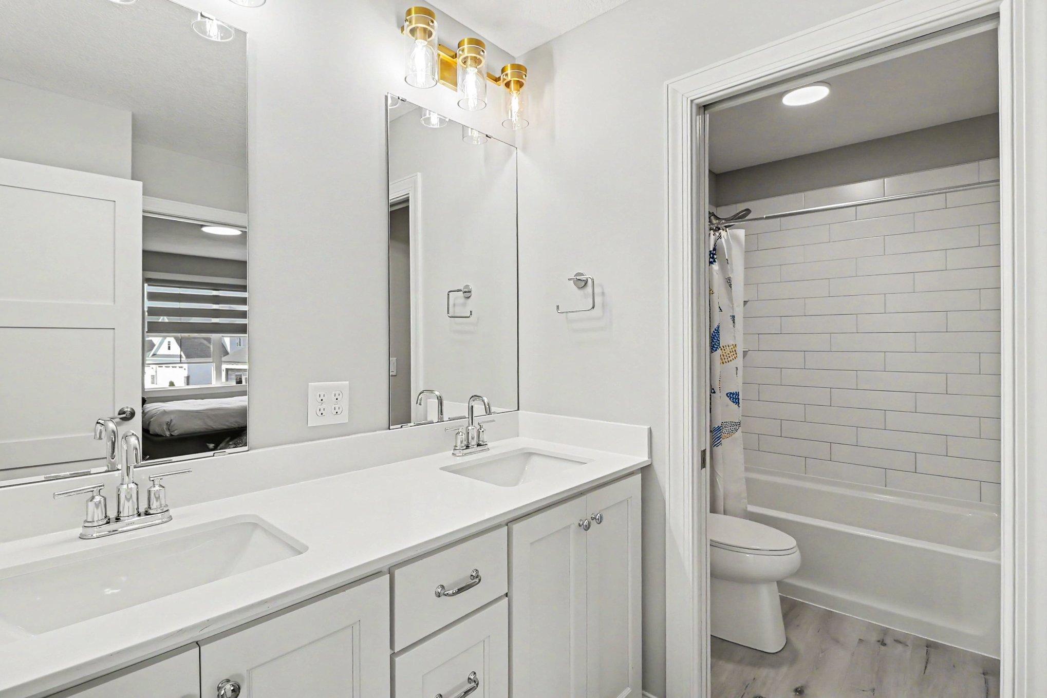 Jack and Jill bathroom with custom tile and double vanity.
