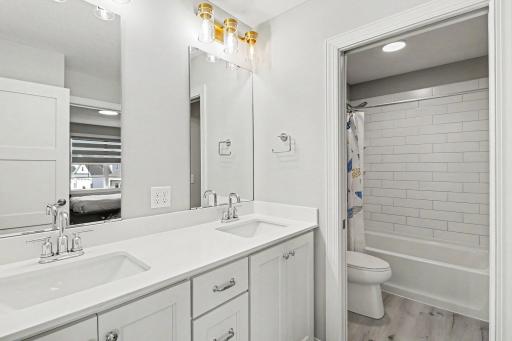 Jack and Jill bathroom with custom tile and double vanity.